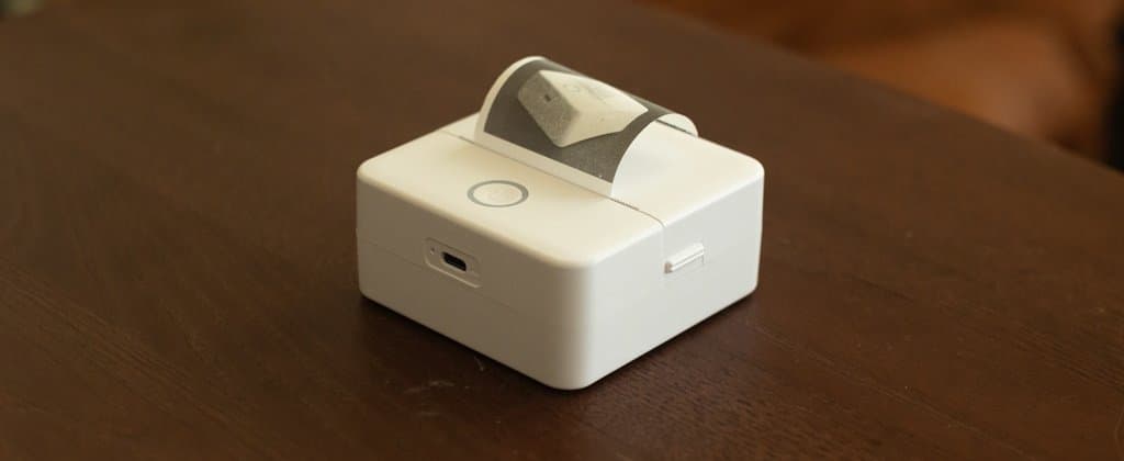 X6h Bluetooth thermal printer producing a print of itself