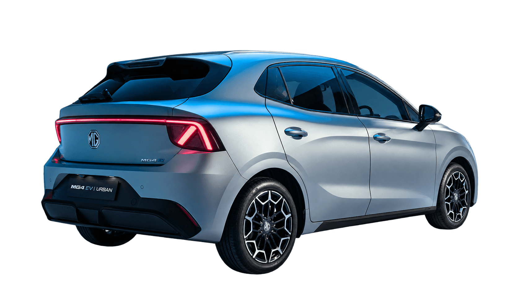 Silver MG4 EV Urban alone on a plain dark blue studio background, viewed from the rear